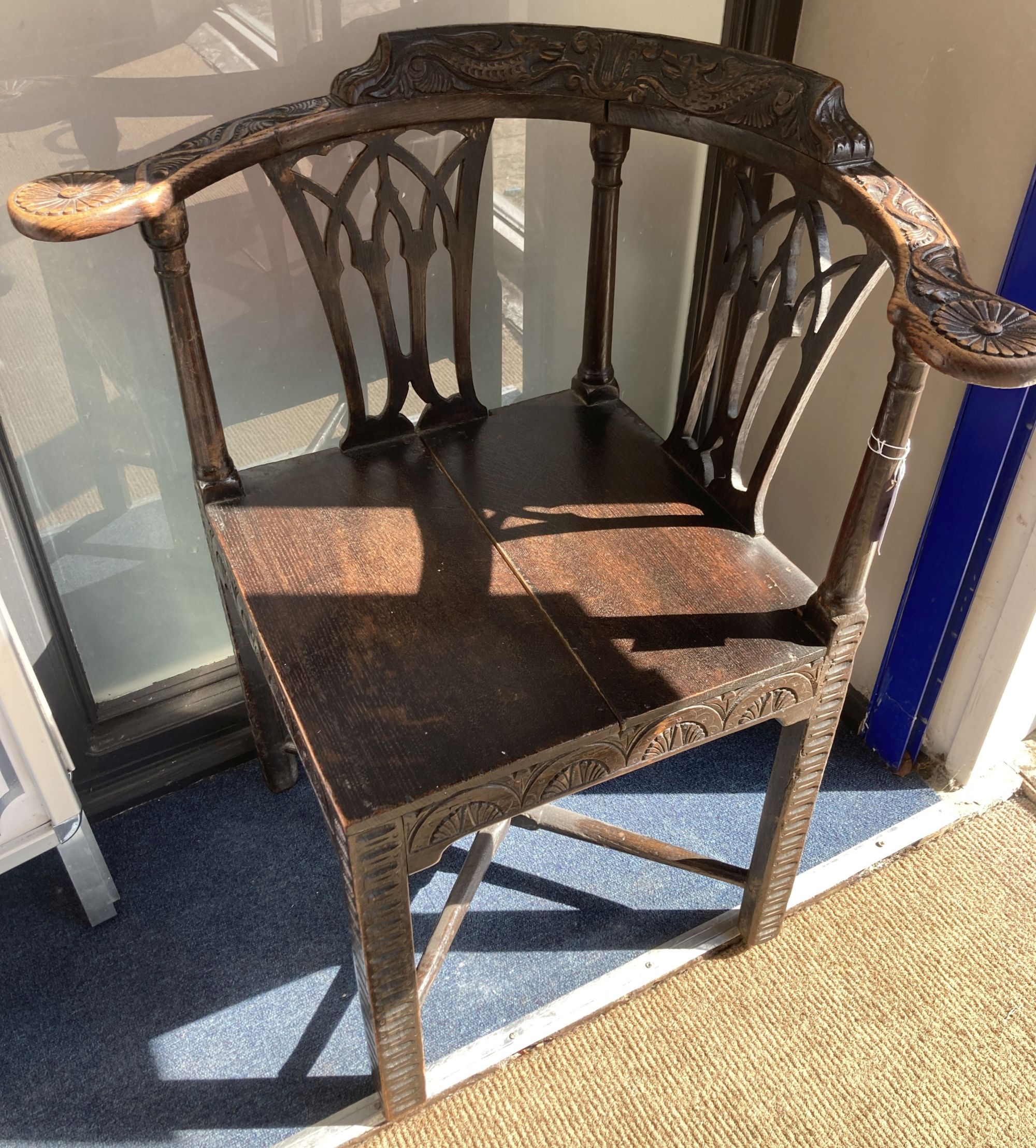 A George III carved mahogany corner elbow chair, width 76cm, depth 64cm, height 82cm